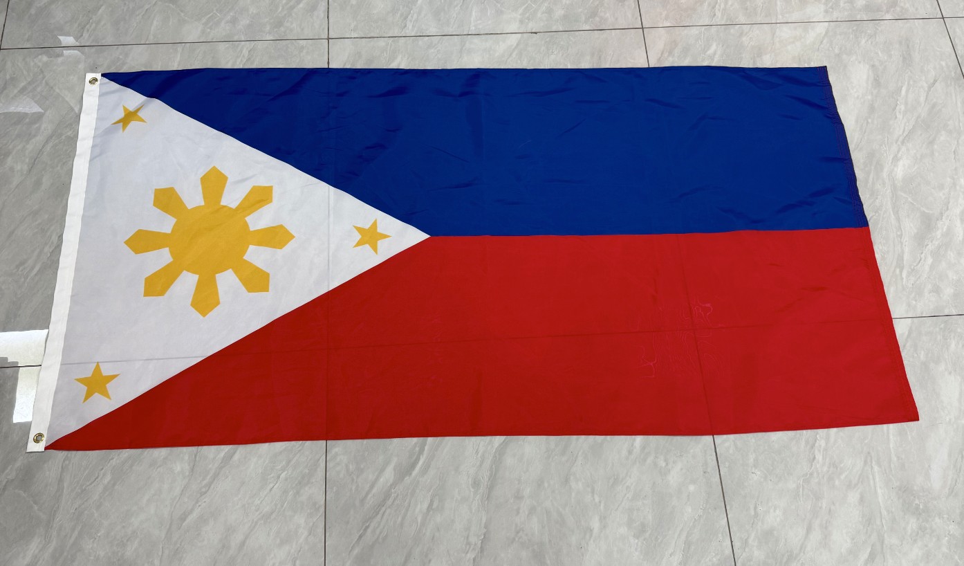 Finished custom flag printing sample laid flat showing printed detail, header sleeve, and grommets
