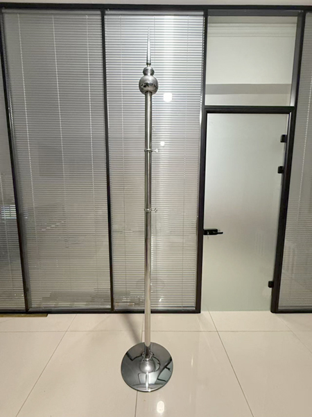 custom sectional flagpole with weighted floor base installed in a commercial interior