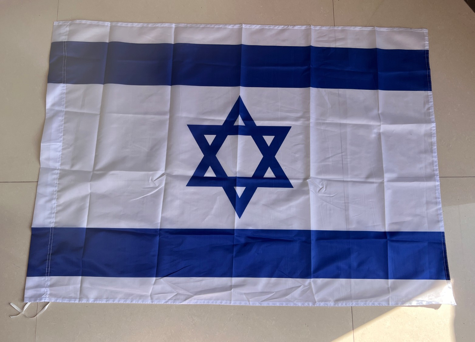 Custom printed national flag in polyester with blue stripes and emblem