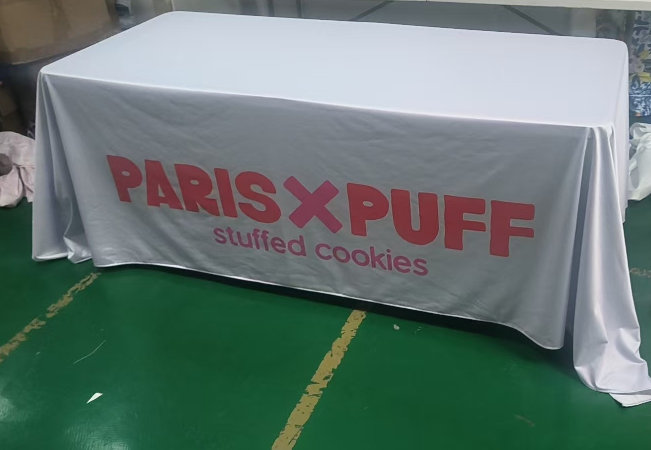 White 250 gsm polyester table cover printed with a brand logo for a US confectionery client