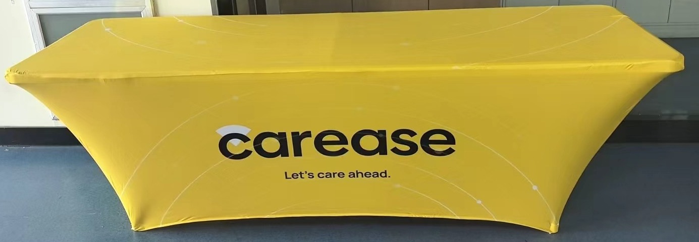 Yellow 180 gsm stretch table cover printed with a client logo on an 8 ft exhibition table